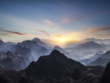 Aerial view of misty mountains at sunrise